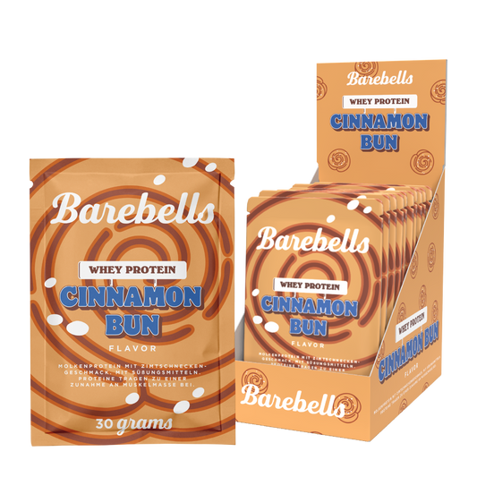 Barebells Cinnamon Bun flavor whey protein packets, showing a single packet, a small stack, and a larger retail display box on a clean white background.